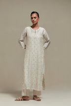Off white silk Chanderi straight kurta set with all-over delicate embroidered flowers, highlighted with sequins and beads.