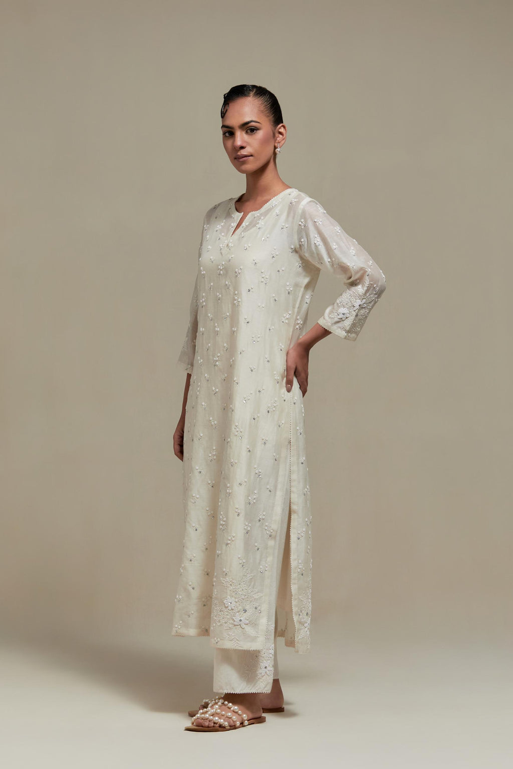 Off white silk Chanderi straight kurta set with all-over delicate embroidered flowers, highlighted with sequins and beads.