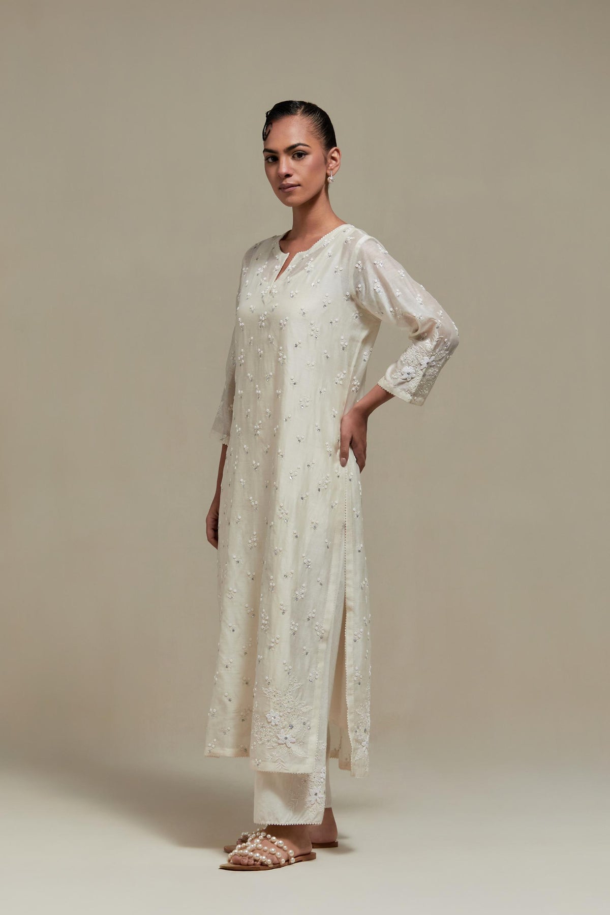 Off white silk Chanderi straight kurta set with all-over delicate embroidered flowers, highlighted with sequins and beads.