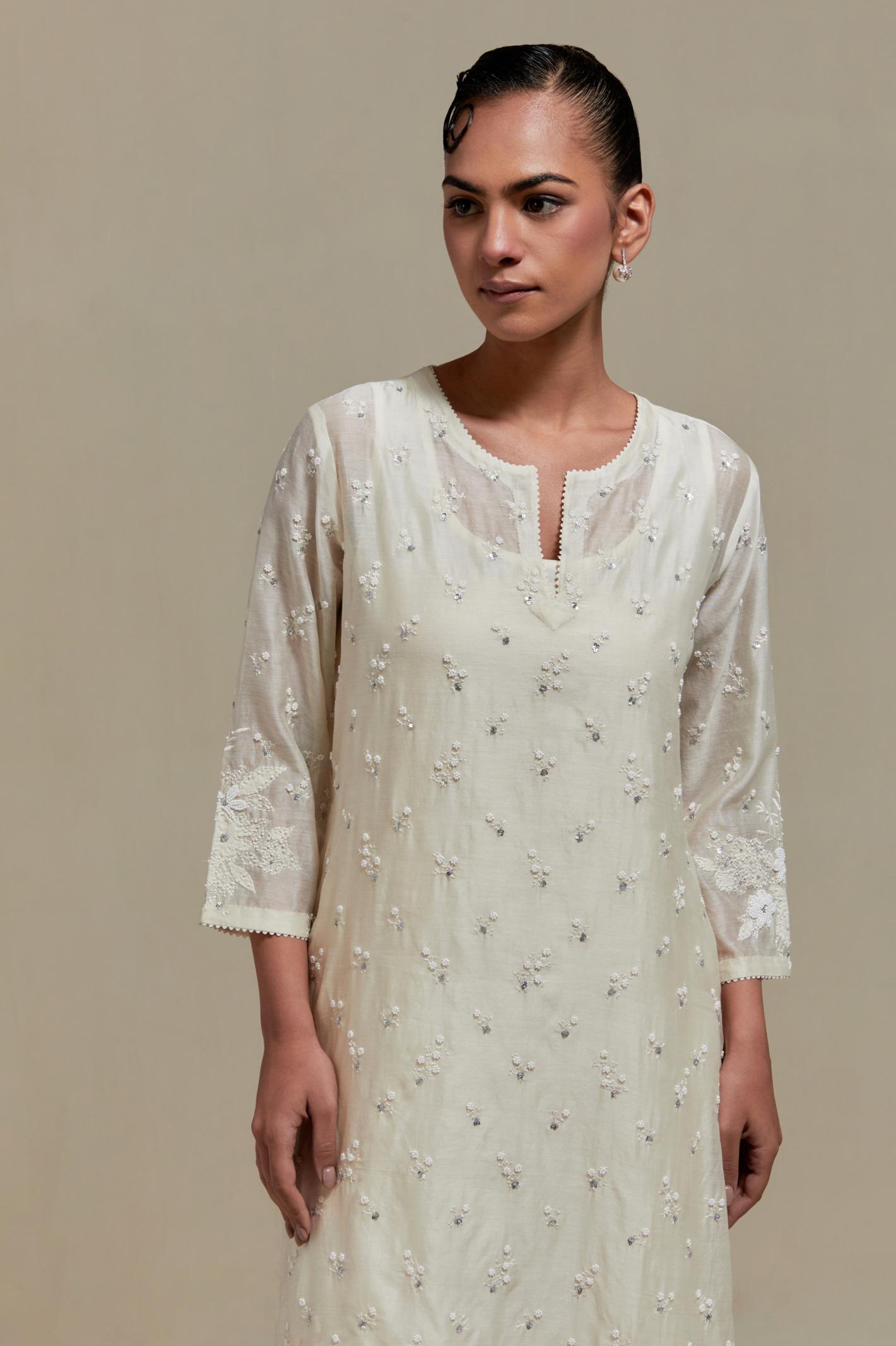 Off white silk Chanderi straight kurta set with all-over delicate embroidered flowers, highlighted with sequins and beads.