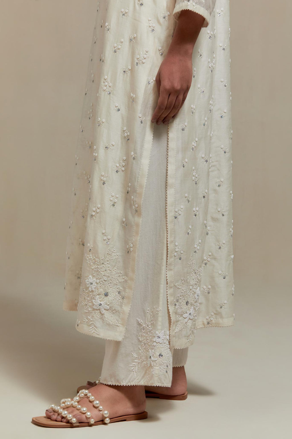 Off white silk Chanderi straight kurta set with all-over delicate embroidered flowers, highlighted with sequins and beads.