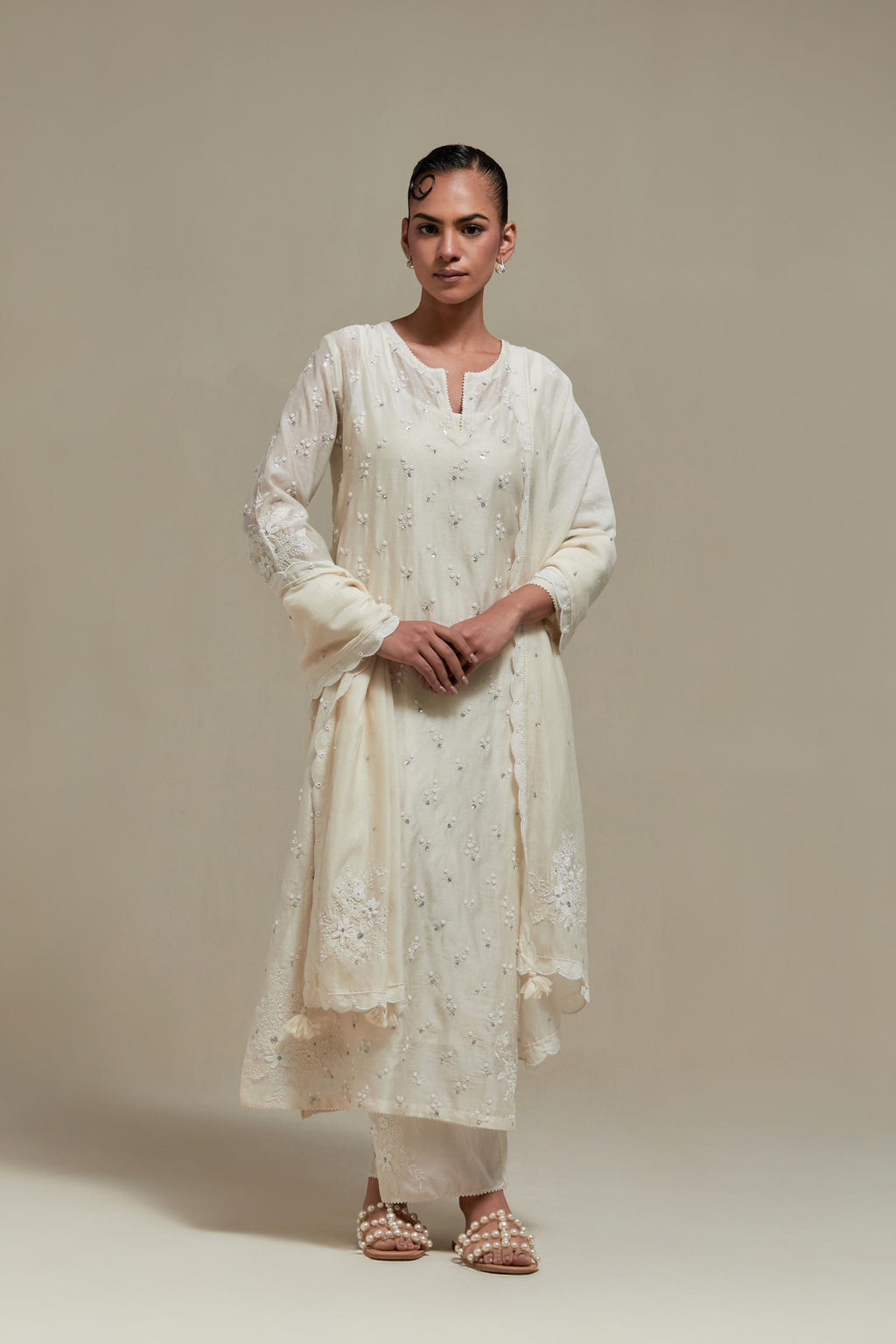 Off white silk Chanderi straight kurta set with all-over delicate embroidered flowers, highlighted with sequins and beads.