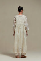 Off white cotton Chanderi kurta dress with delicate embroidered flowers and appliqué motifs, highlighted with sequins and beads.