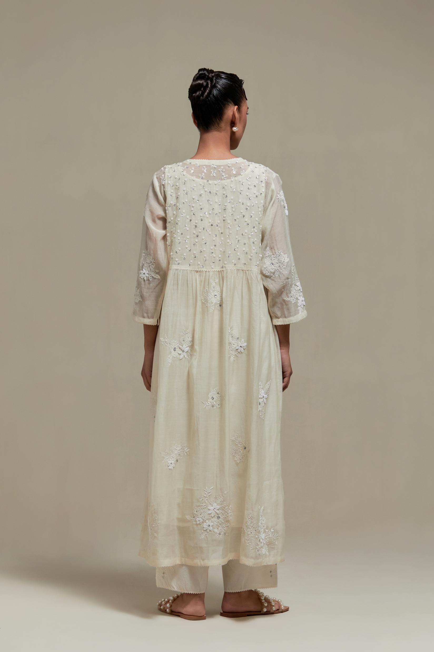Off white cotton Chanderi kurta dress with delicate embroidered flowers and appliqué motifs, highlighted with sequins and beads.