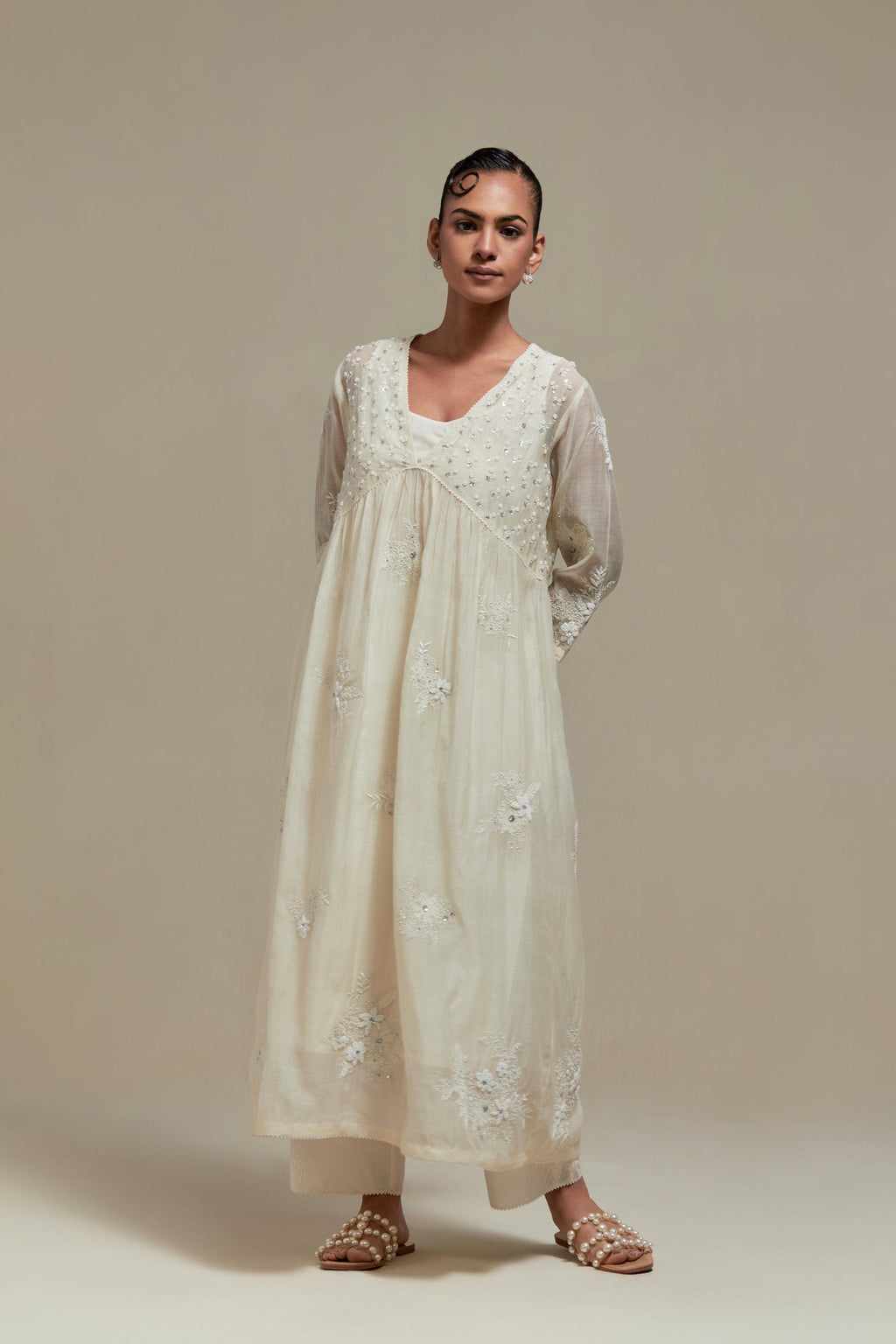 Off white cotton Chanderi kurta dress with delicate embroidered flowers and appliqué motifs, highlighted with sequins and beads.