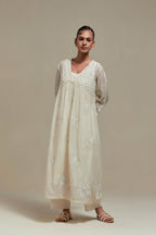 Off white cotton Chanderi kurta dress with delicate embroidered flowers and appliqué motifs, highlighted with sequins and beads.