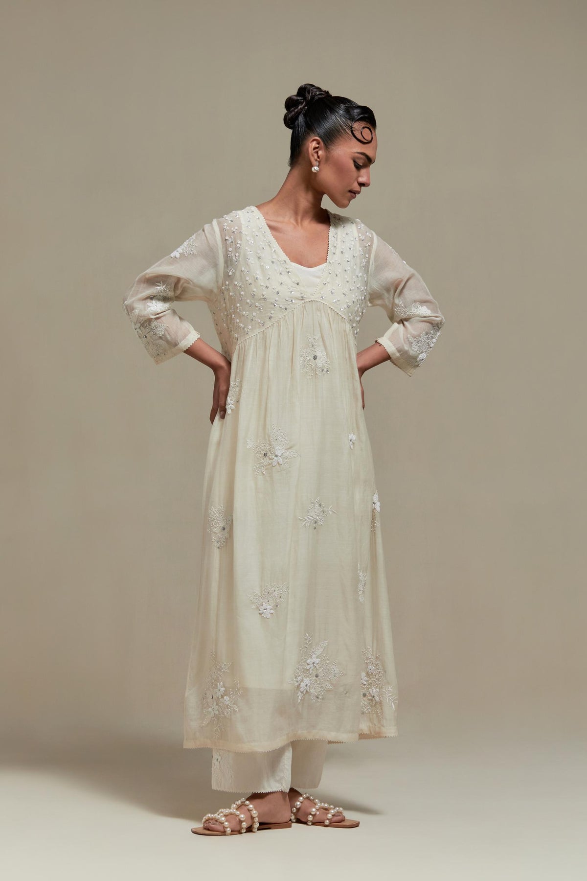 Off white cotton Chanderi kurta dress with delicate embroidered flowers and appliqué motifs, highlighted with sequins and beads.