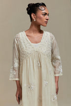 Off white cotton Chanderi kurta dress with delicate embroidered flowers and appliqué motifs, highlighted with sequins and beads.