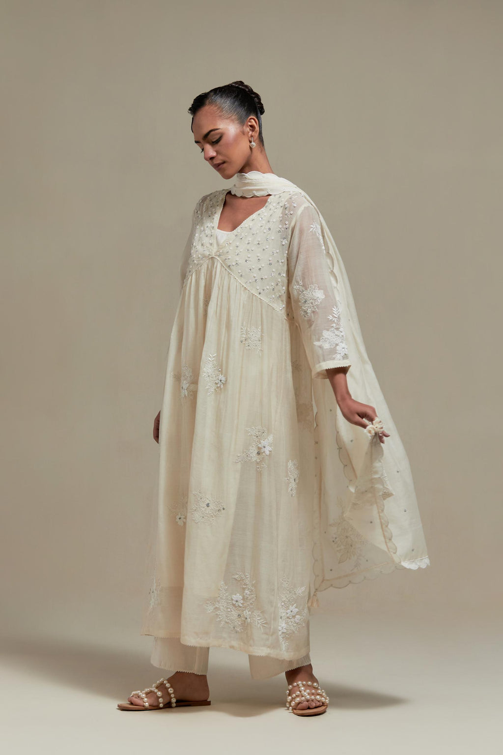 Off white cotton Chanderi kurta dress with delicate embroidered flowers and appliqué motifs, highlighted with sequins and beads.