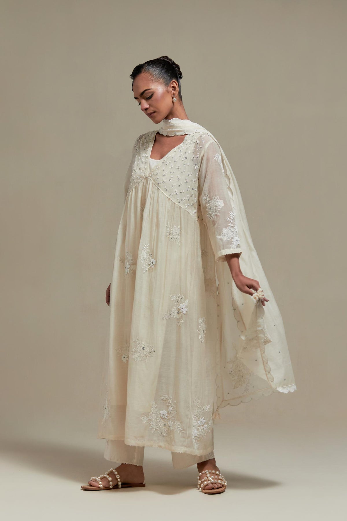 Off white cotton Chanderi kurta dress with delicate embroidered flowers and appliqué motifs, highlighted with sequins and beads.