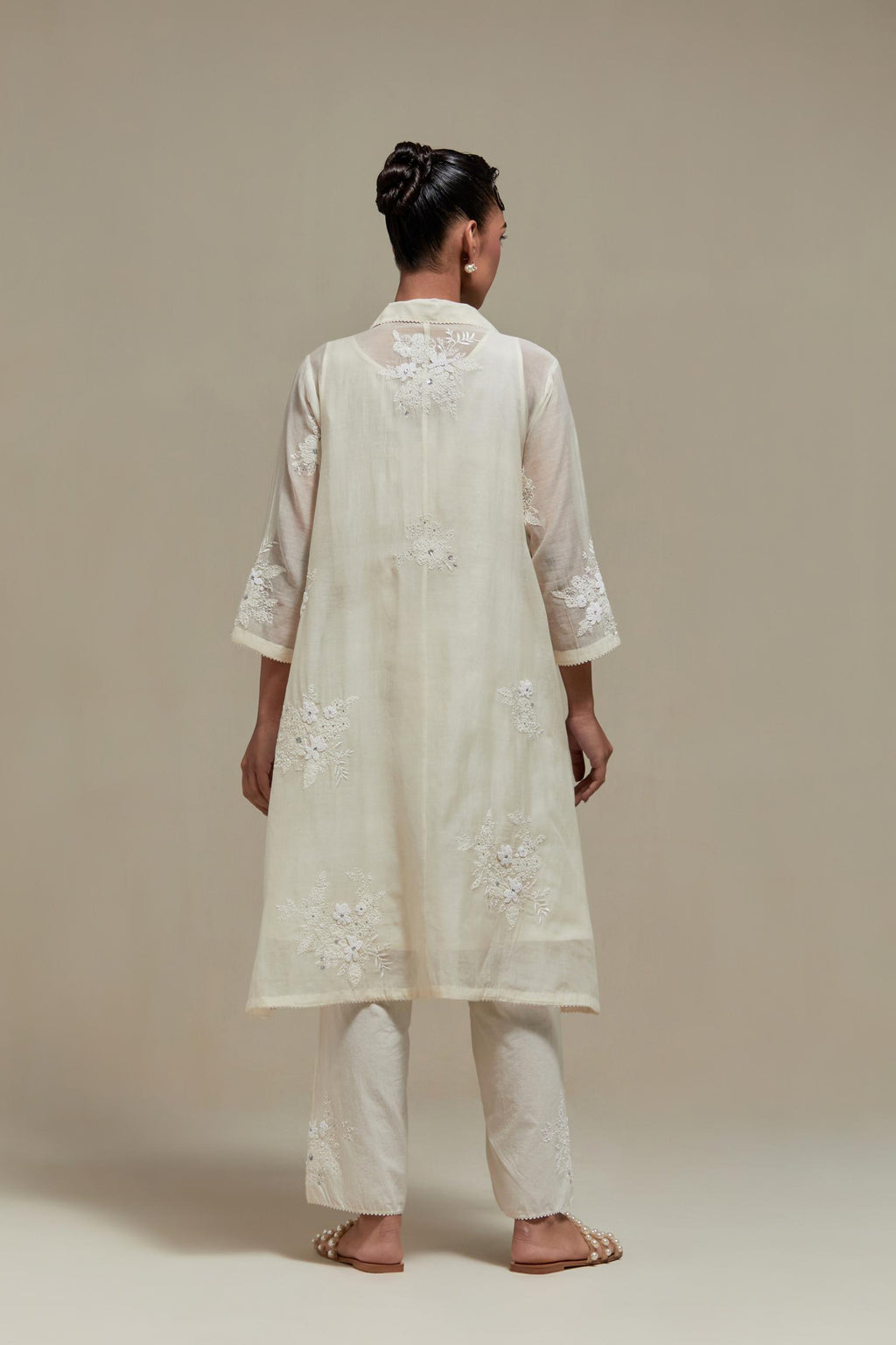 Off white cotton Chanderi short shirt-kurta set with all-over appliqué flowers, highlighted with sequins and beads.