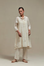 Off white cotton Chanderi short shirt-kurta set with all-over appliqué flowers, highlighted with sequins and beads.