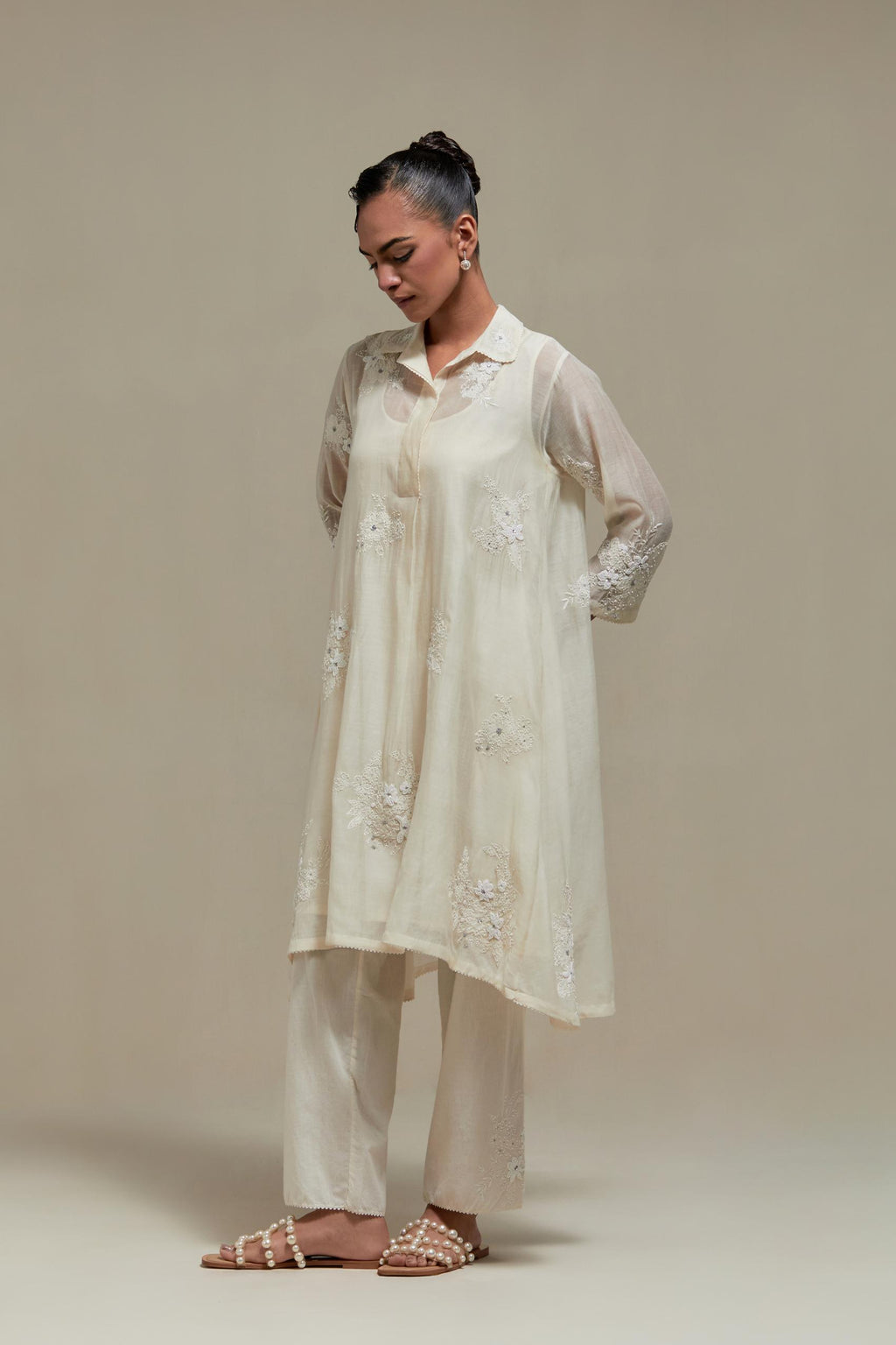 Off white cotton Chanderi short shirt-kurta set with all-over appliqué flowers, highlighted with sequins and beads.