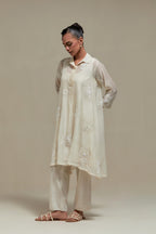 Off white cotton Chanderi short shirt-kurta set with all-over appliqué flowers, highlighted with sequins and beads.