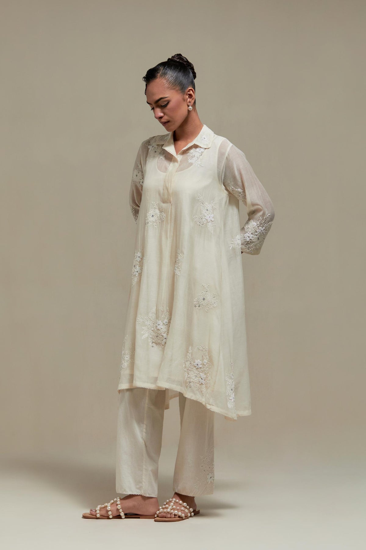 Off white cotton Chanderi short shirt-kurta set with all-over appliqué flowers, highlighted with sequins and beads.