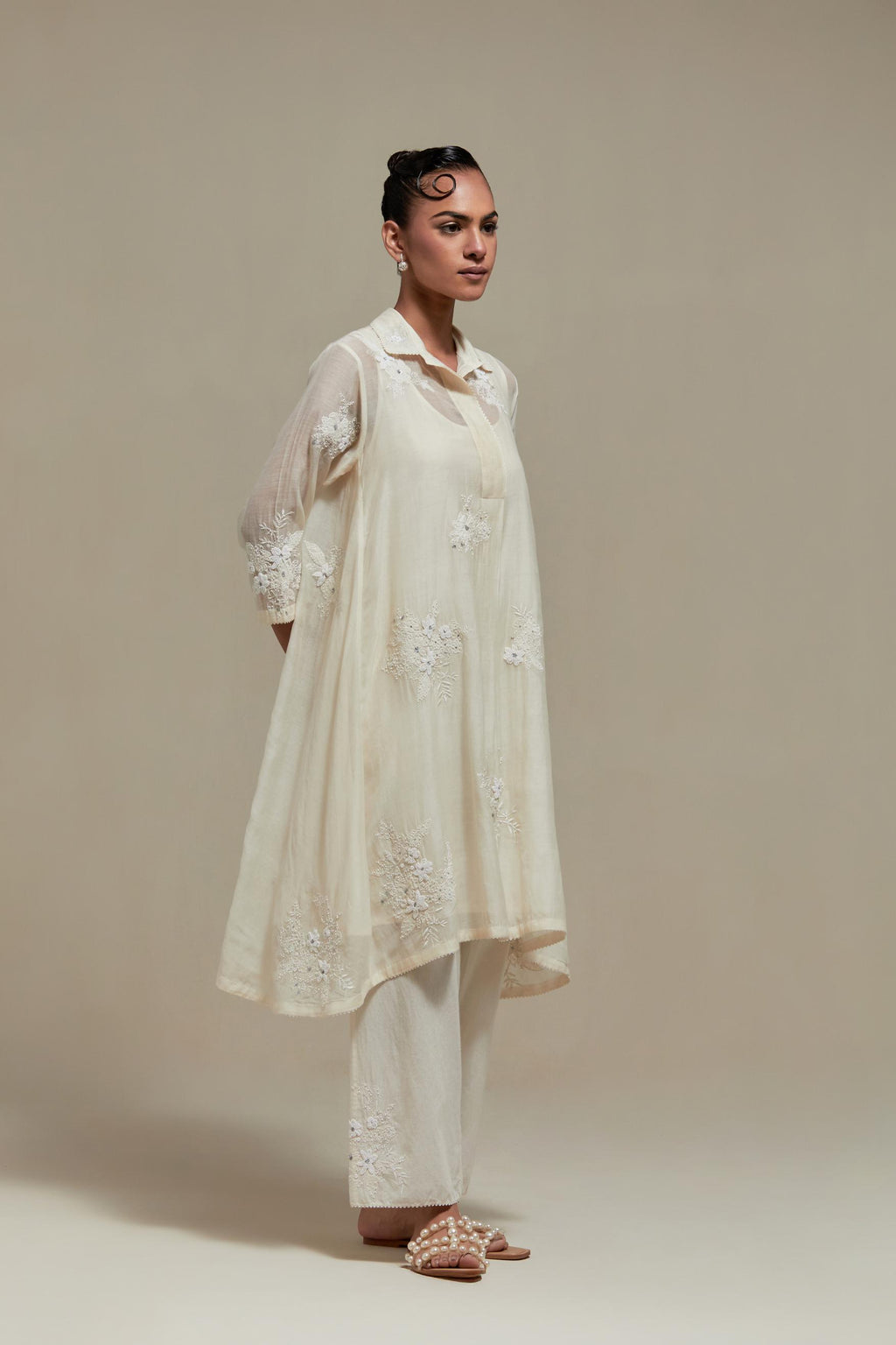 Off white cotton Chanderi short shirt-kurta set with all-over appliqué flowers, highlighted with sequins and beads.