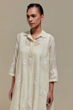 Off white cotton Chanderi short shirt-kurta set with all-over appliqué flowers, highlighted with sequins and beads.