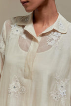 Off white cotton Chanderi short shirt-kurta set with all-over appliqué flowers, highlighted with sequins and beads.