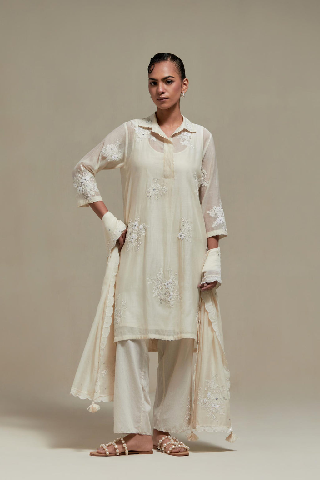 Off white cotton Chanderi short shirt-kurta set with all-over appliqué flowers, highlighted with sequins and beads.