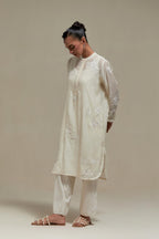 Off white cotton Chanderi short kurta set with all-over appliqué, highlighted with sequins and beads.