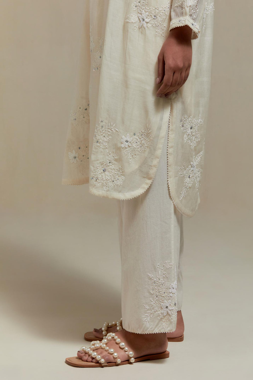 Off white cotton Chanderi short kurta set with all-over appliqué, highlighted with sequins and beads.