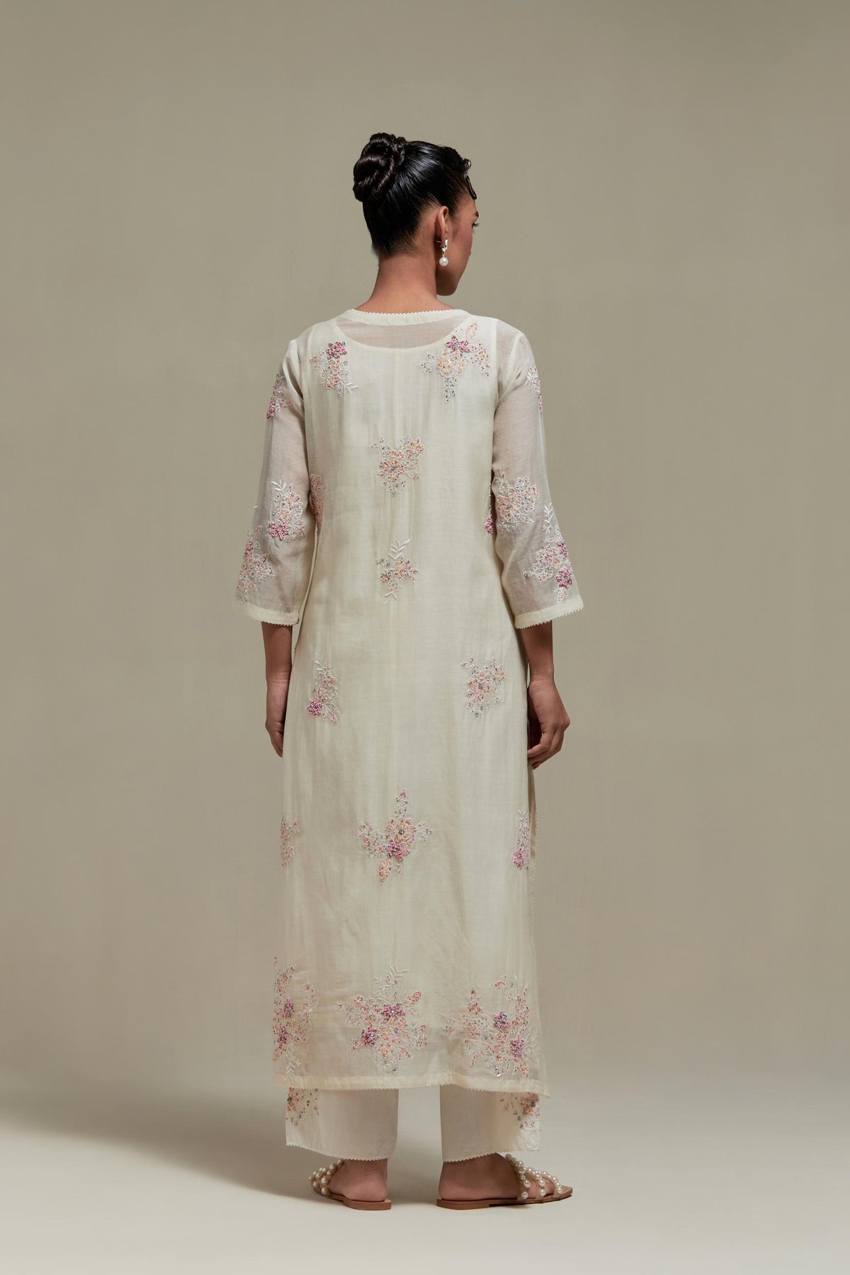 Off white straight kurta set with all-over pink & beige hand block printed appliqué motifs, highlighted with sequins and multi coloured beads.