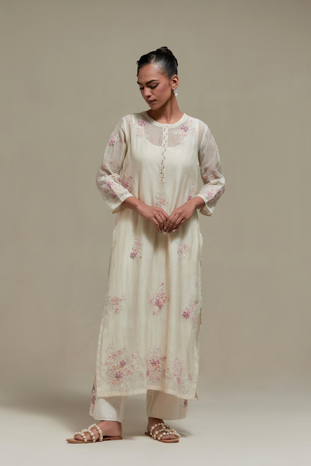 Off white straight kurta set with all-over pink & beige hand block printed appliqué motifs, highlighted with sequins and multi coloured beads.
