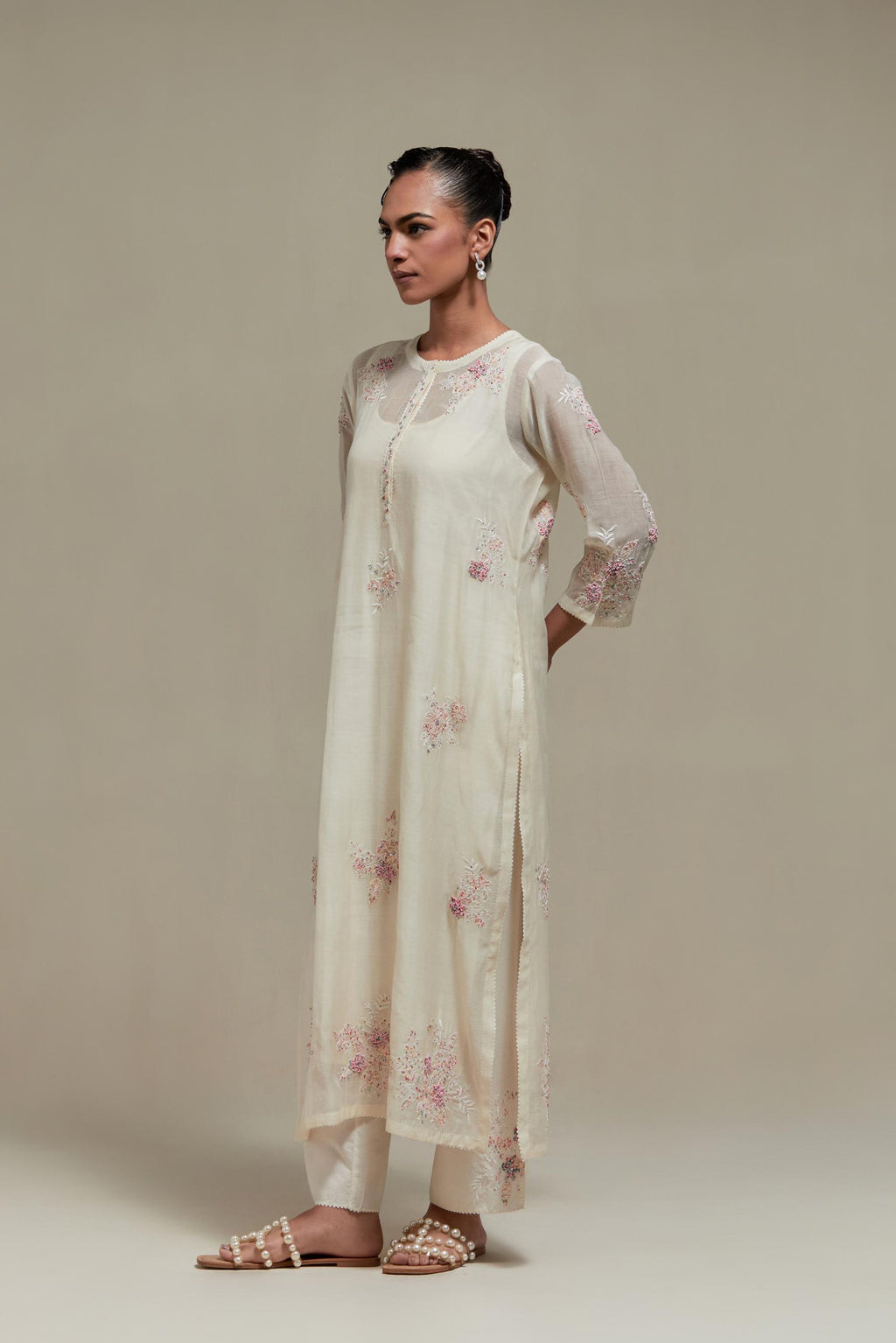 Off white straight kurta set with all-over pink & beige hand block printed appliqué motifs, highlighted with sequins and multi coloured beads.