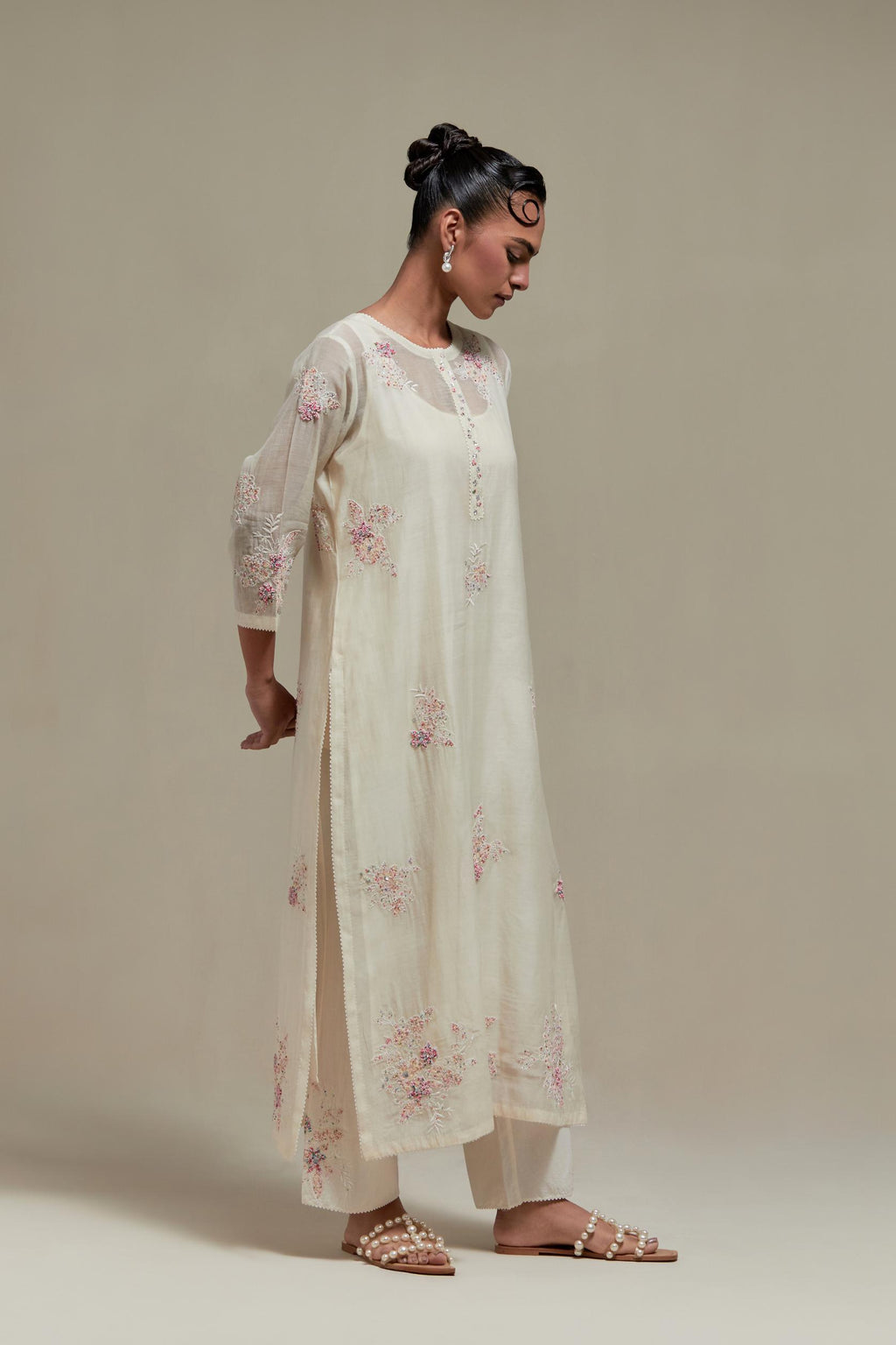 Off white straight kurta set with all-over pink & beige hand block printed appliqué motifs, highlighted with sequins and multi coloured beads.