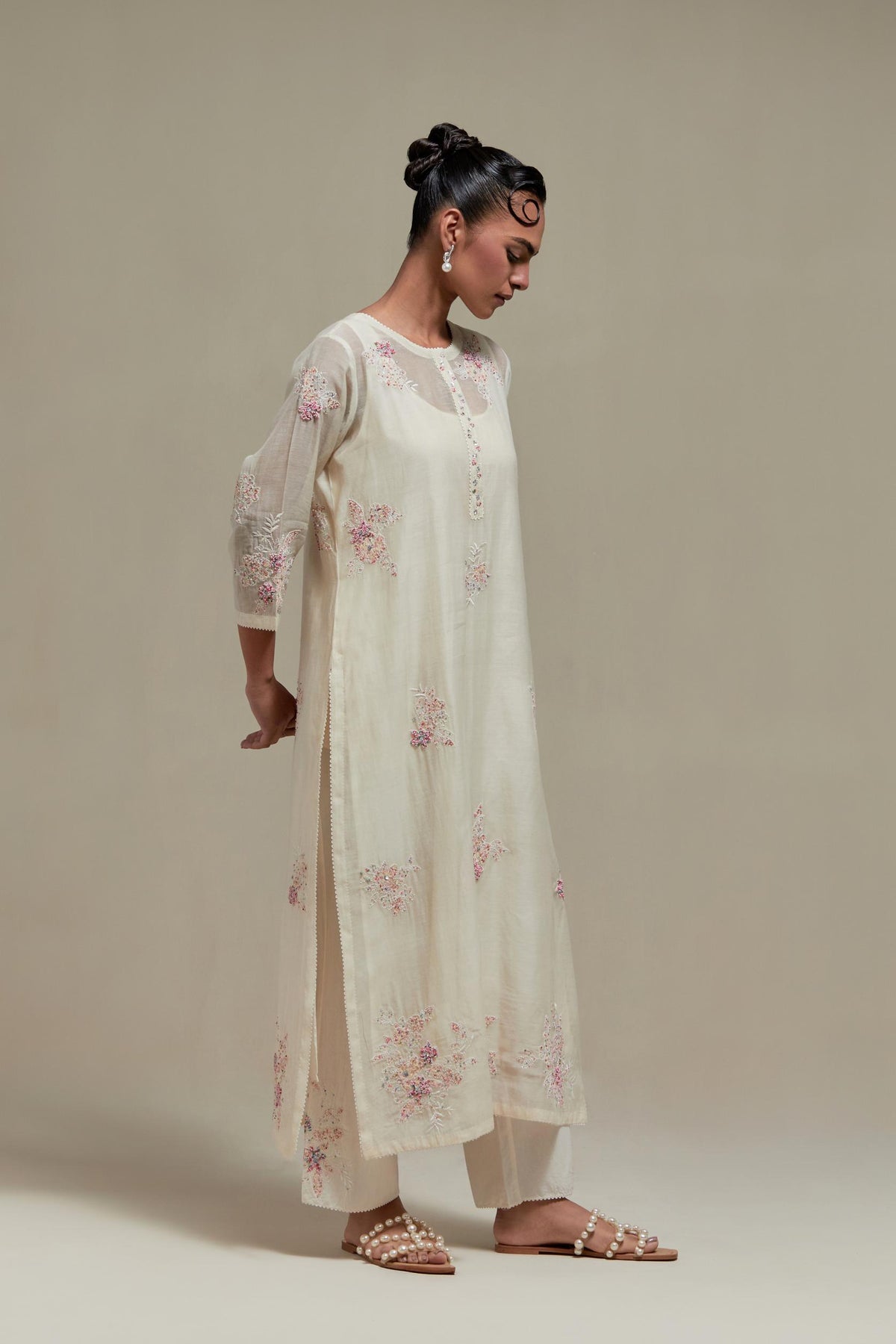 Off white straight kurta set with all-over pink & beige hand block printed appliqué motifs, highlighted with sequins and multi coloured beads.