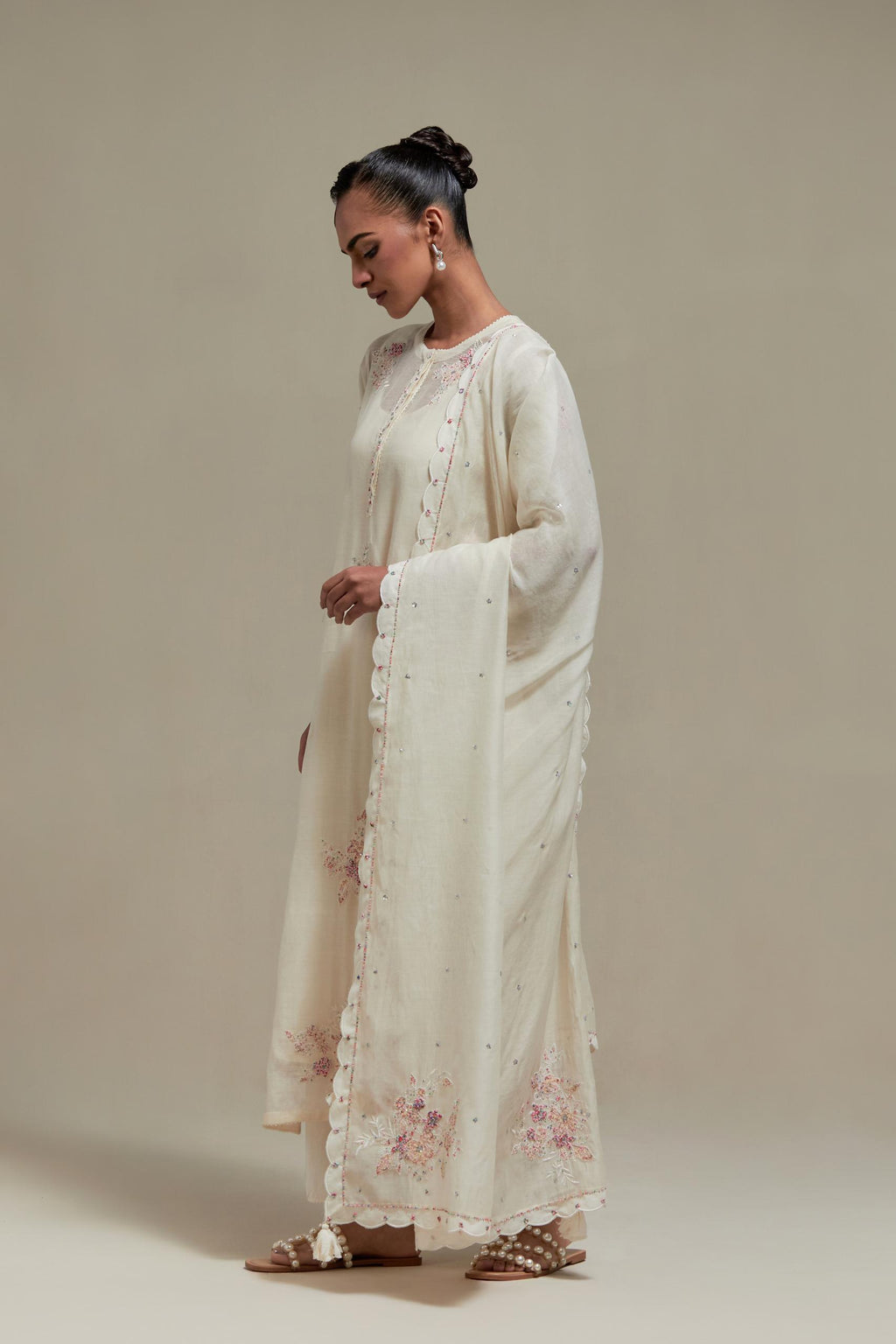Off white cotton Chanderi dupatta, highlighted with all-over delicate sequins flower and pink & beige hand block printed appliqué motifs at dupatta corners.