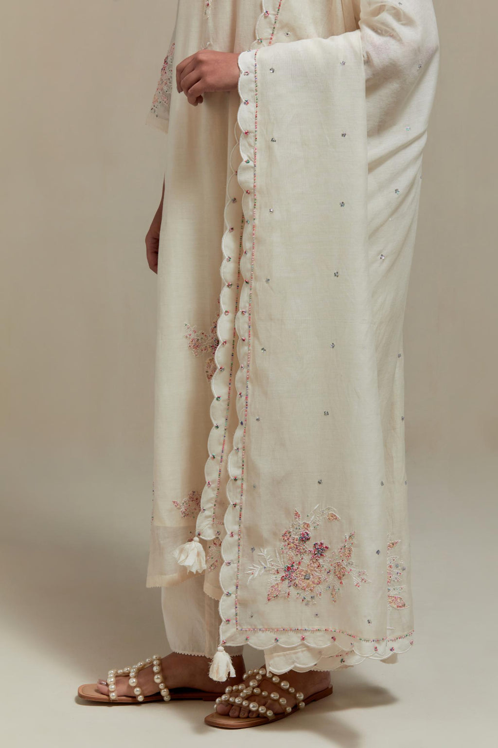 Off white cotton Chanderi dupatta, highlighted with all-over delicate sequins flower and pink & beige hand block printed appliqué motifs at dupatta corners.