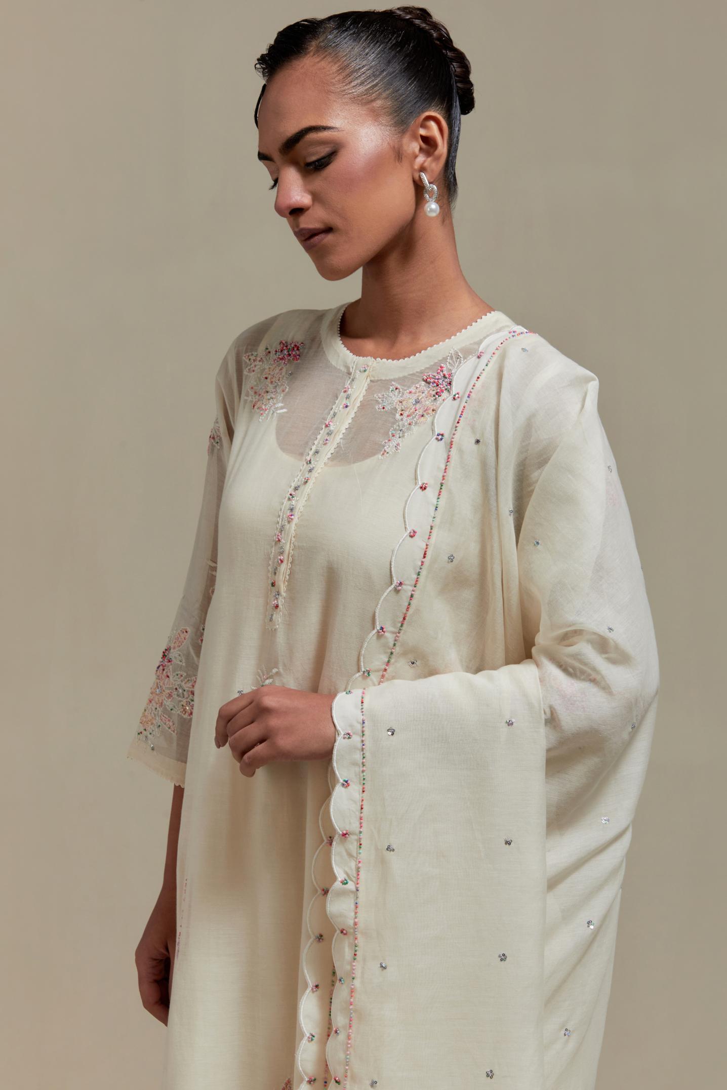Off white cotton Chanderi dupatta, highlighted with all-over delicate sequins flower and pink & beige hand block printed appliqué motifs at dupatta corners.
