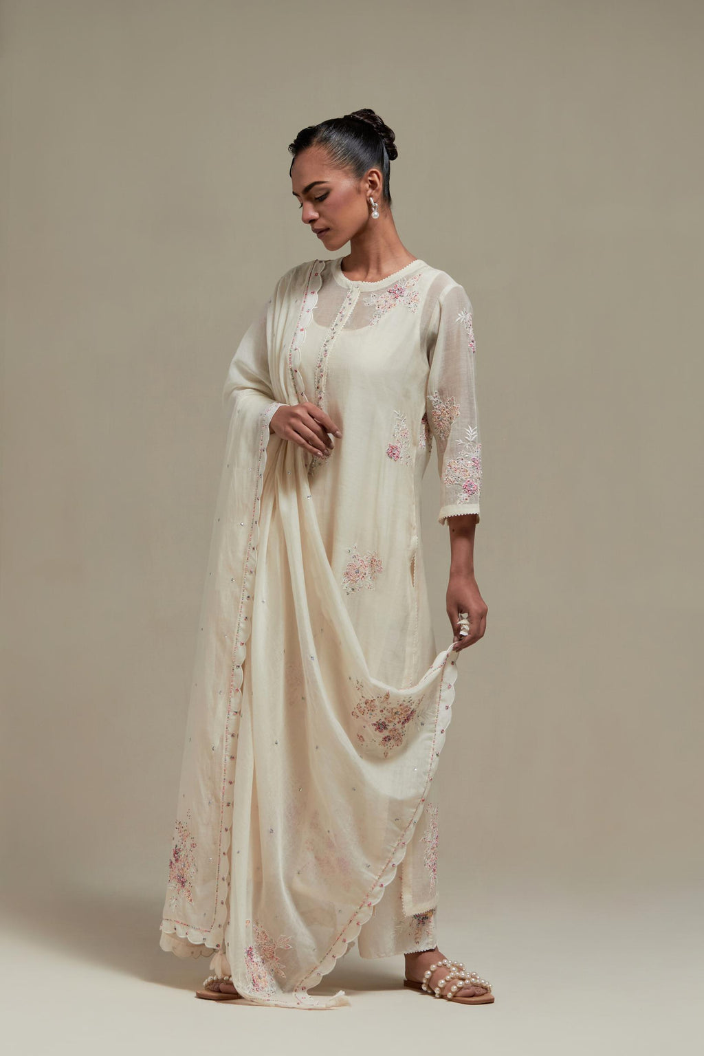 Off white cotton Chanderi dupatta, highlighted with all-over delicate sequins flower and pink & beige hand block printed appliqué motifs at dupatta corners.
