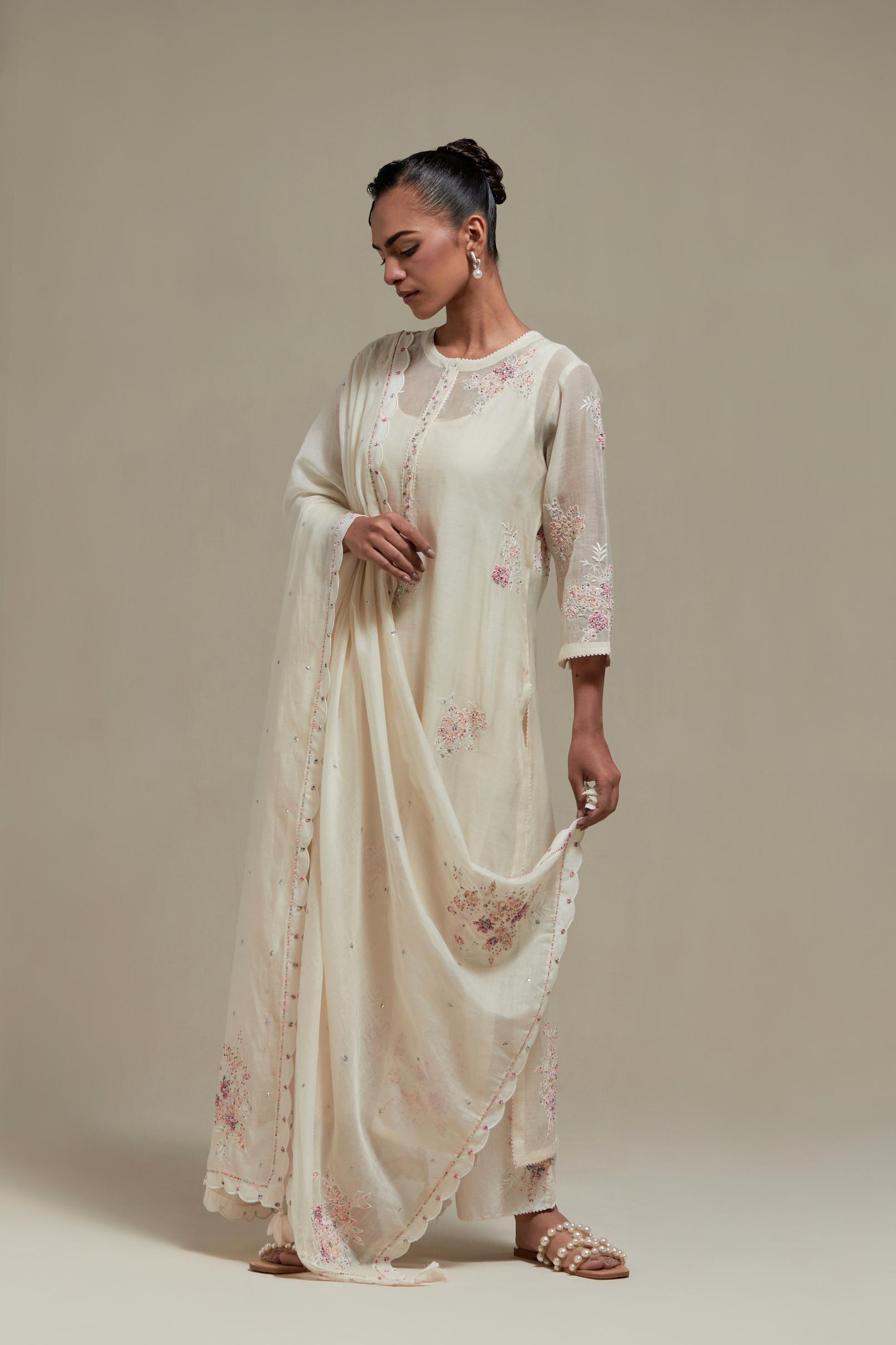 Off white cotton Chanderi dupatta, highlighted with all-over delicate sequins flower and pink & beige hand block printed appliqué motifs at dupatta corners.