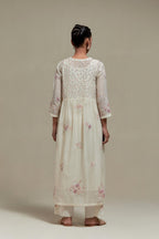 Off white cotton Chanderi kurta dress set with delicate embroidered flowers and pink & beige hand block printed appliqué motifs, highlighted with sequins and multi coloured beads.