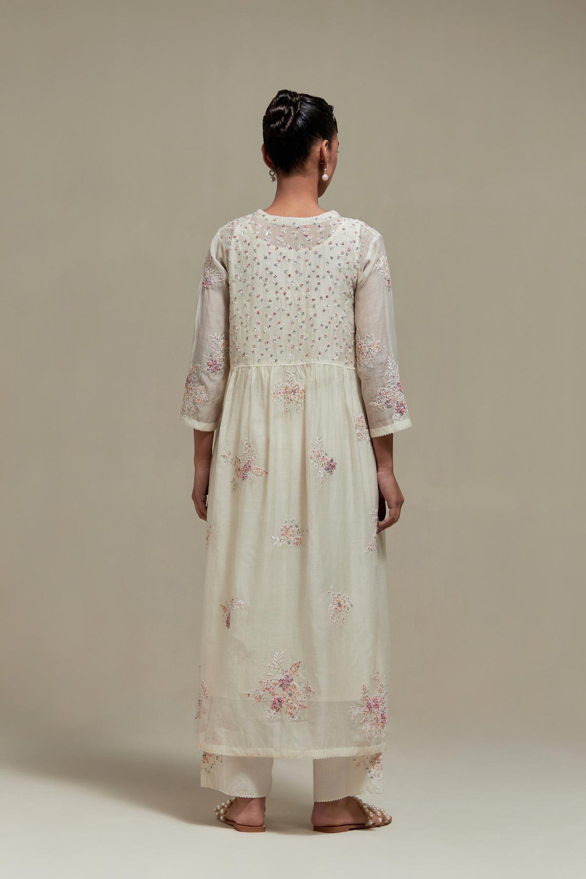 Off white cotton Chanderi kurta dress set with delicate embroidered flowers and pink & beige hand block printed appliqué motifs, highlighted with sequins and multi coloured beads.