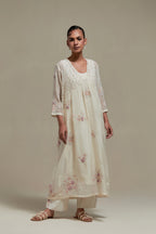 Off white cotton Chanderi kurta dress set with delicate embroidered flowers and pink & beige hand block printed appliqué motifs, highlighted with sequins and multi coloured beads.