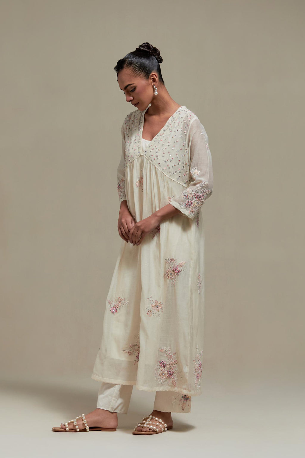Off white cotton Chanderi kurta dress set with delicate embroidered flowers and pink & beige hand block printed appliqué motifs, highlighted with sequins and multi coloured beads.