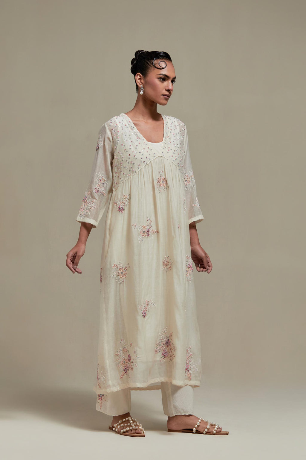 Off white cotton Chanderi kurta dress set with delicate embroidered flowers and pink & beige hand block printed appliqué motifs, highlighted with sequins and multi coloured beads.