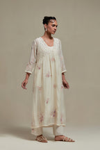 Off white cotton Chanderi kurta dress set with delicate embroidered flowers and pink & beige hand block printed appliqué motifs, highlighted with sequins and multi coloured beads.