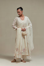 Off white cotton Chanderi kurta dress set with delicate embroidered flowers and pink & beige hand block printed appliqué motifs, highlighted with sequins and multi coloured beads.