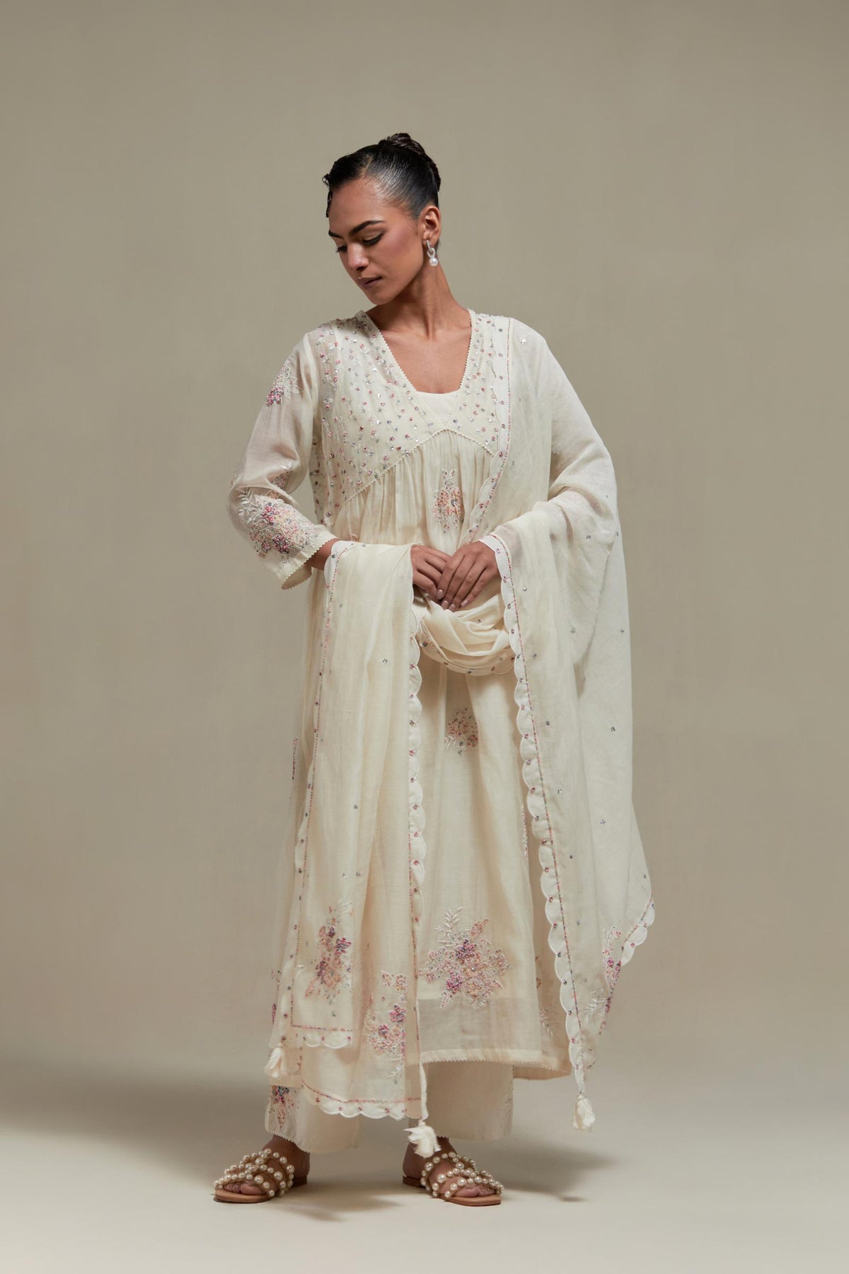 Off white cotton Chanderi kurta dress set with delicate embroidered flowers and pink & beige hand block printed appliqué motifs, highlighted with sequins and multi coloured beads.
