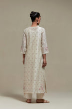 Off white silk Chanderi straight kurta set with all-over delicate embroidered flowers, highlighted with sequins and multi coloured beads.