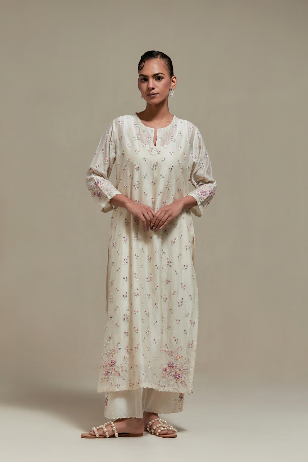 Off white silk Chanderi straight kurta set with all-over delicate embroidered flowers, highlighted with sequins and multi coloured beads.