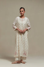 Off white silk Chanderi straight kurta set with all-over delicate embroidered flowers, highlighted with sequins and multi coloured beads.