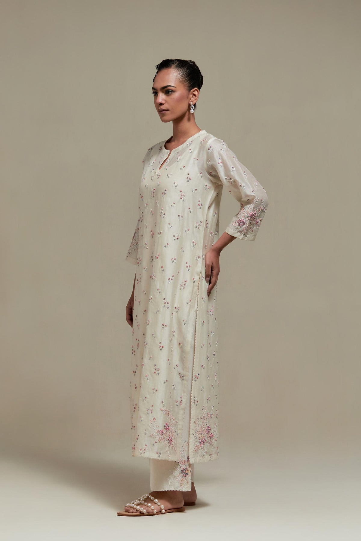 Off white silk Chanderi straight kurta set with all-over delicate embroidered flowers, highlighted with sequins and multi coloured beads.