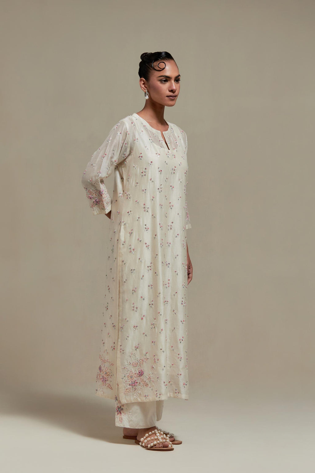 Off white silk Chanderi straight kurta set with all-over delicate embroidered flowers, highlighted with sequins and multi coloured beads.