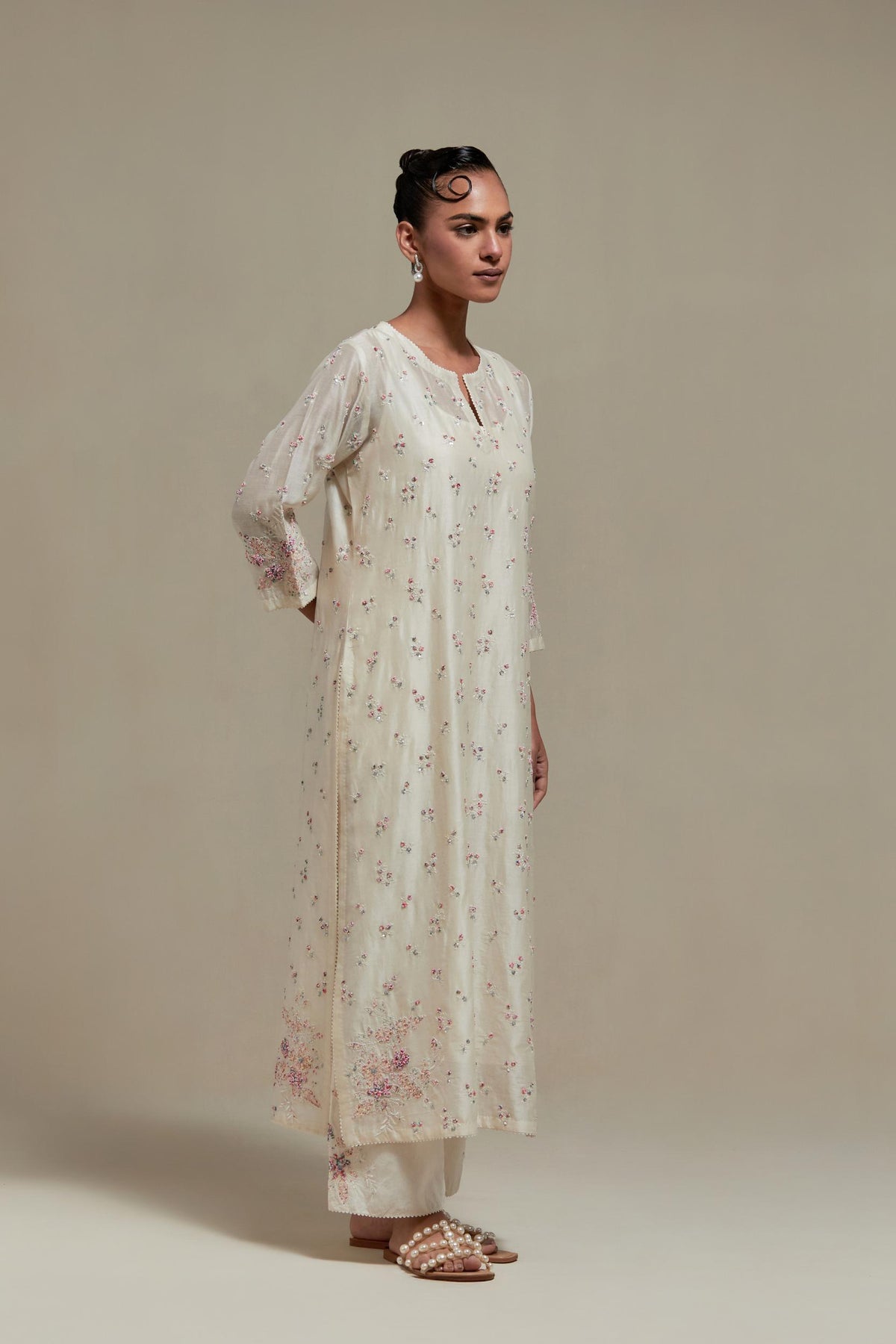 Off white silk Chanderi straight kurta set with all-over delicate embroidered flowers, highlighted with sequins and multi coloured beads.