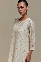 Off white silk Chanderi straight kurta set with all-over delicate embroidered flowers, highlighted with sequins and multi coloured beads.